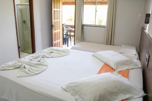 En eller flere senger på et rom på Hotel Amendoeiras