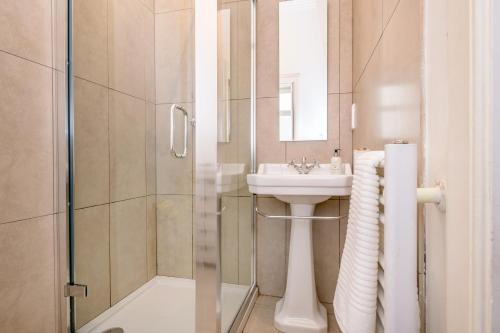a bathroom with a sink and a shower at Mansefield House in Arrochar