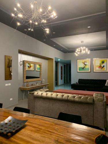 a living room with a couch and a table at CASA LUZ Hospedaje, Pereira , Cerritos in Pereira