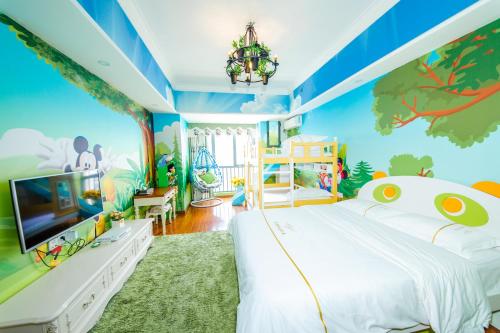 a childs bedroom with a dinosaur themed wall at Lavender Apartment in Guangzhou