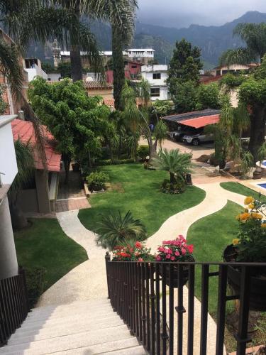 a view of a garden from a balcony at Hotel Concierge Flor y Canto in Tepoztlán