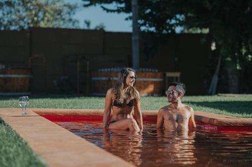a man and a woman sitting in a swimming pool at Hotel Boutique BC Wine Casablanca in Casablanca