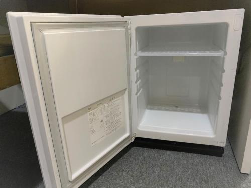 an empty refrigerator with its door open in a room at Hotel 1-2-3 Kokura in Kitakyushu