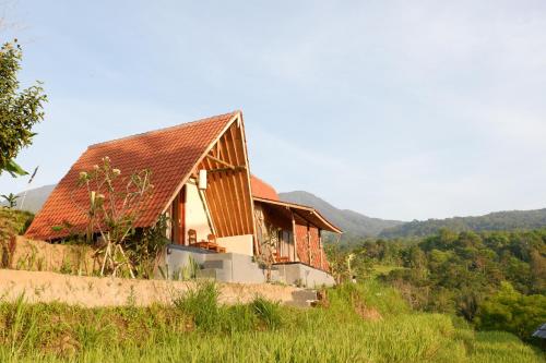 a house with a red roof on a hill at Padi Bali Jatiluwih in Tabanan
