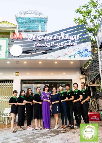 a group of people standing in front of a restaurant at Can Tho Orchid Garden Homestay in Can Tho