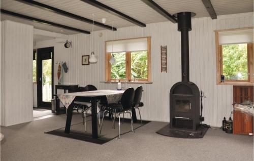 a room with a table and a wood stove at Beautiful Home In Bogense With Kitchen in Bogense