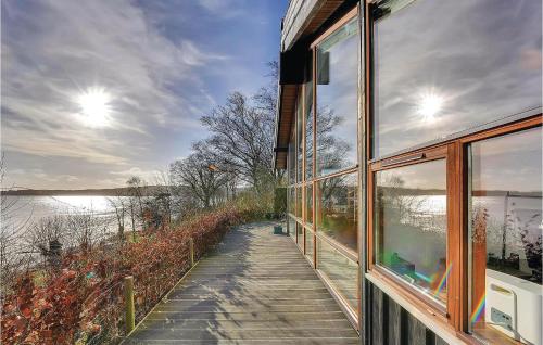 a house with a walkway next to a window at Three-Bedroom Holiday Home Bjert With Sea View 08 in Sønder Bjert