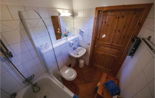 a bathroom with a tub and a sink and a toilet at Awesome Home In St,georgen A,kreischb, With 1 Bedrooms, Internet And Indoor Swimming Pool in Sankt Lorenzen ob Murau