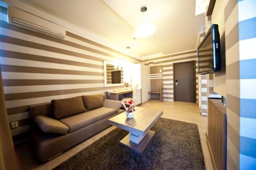 a living room with a couch and a coffee table at Hotel Confort in Cluj-Napoca