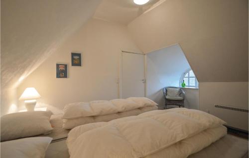 a bedroom with three beds in the corner of a room at Three-Bedroom Holiday Home In Hojer in Højer
