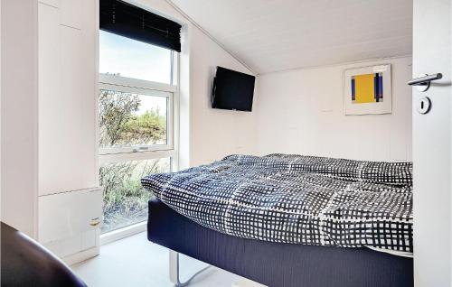 a bedroom with a bed and a window at Three-Bedroom Holiday Home In Henne in Henne Strand