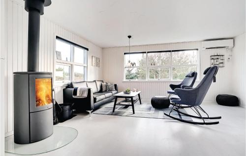 a living room with a couch and a fireplace at Three-Bedroom Holiday Home In Henne in Henne Strand
