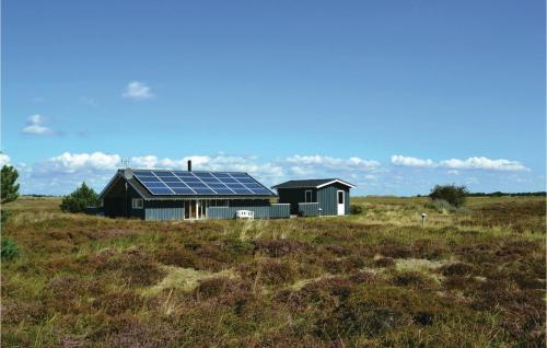 a house with solar panels on it in a field at Holiday Home Bjerges Leje Fanø Iv in Sønderho