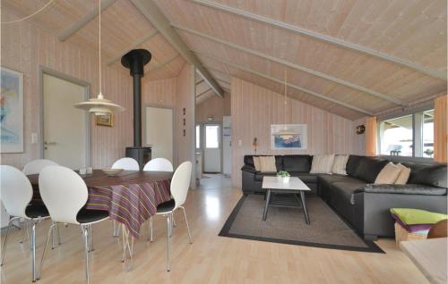 a living room with a couch and a table at Holiday Home Bjerges Leje Fanø Iv in Sønderho