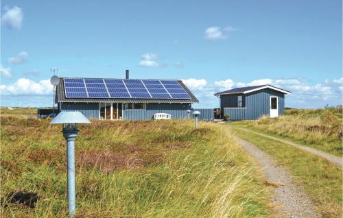 a house with solar panels on the side of a road at Holiday Home Bjerges Leje Fanø Iv in Sønderho