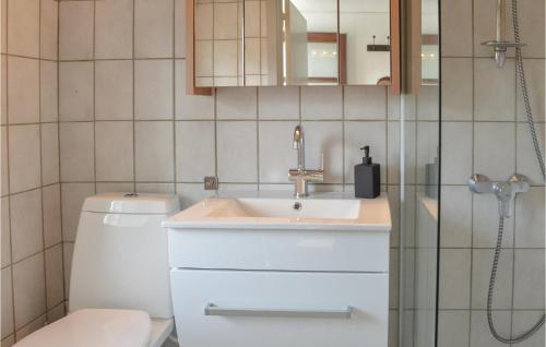 a bathroom with a sink and a toilet at Beautiful Apartment In Rm With Wifi in Rømø Kirkeby
