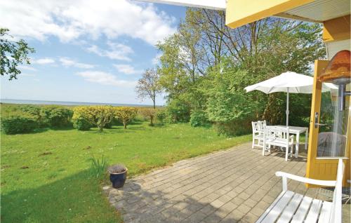 a patio with a table and an umbrella at Holiday Home Birkely Nysted Denm in Nysted