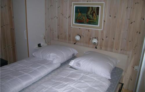 two beds sitting next to each other in a room at Amazing Home In Skagen With 3 Bedrooms, Sauna And Wifi in Hulsig