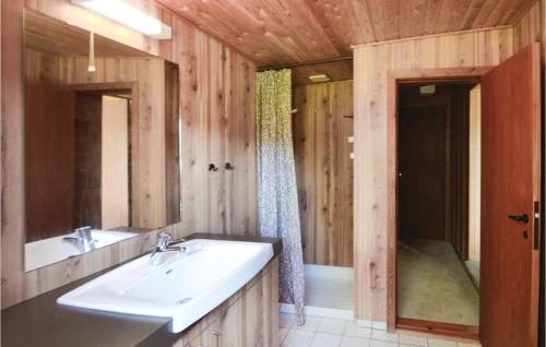 a bathroom with a sink and a bath tub at Three-Bedroom Holiday Home In Frostrup in Frøstrup