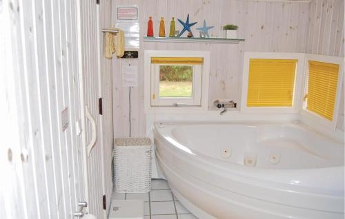 a white bathroom with a tub and a window at Stunning Home In Humble With Wifi in Humble