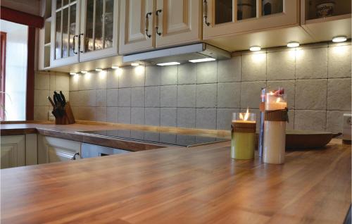 a kitchen with a counter with two lit candles on it at Three-Bedroom Holiday Home In Kirke Eskilstrup in Kirke Eskilstrup