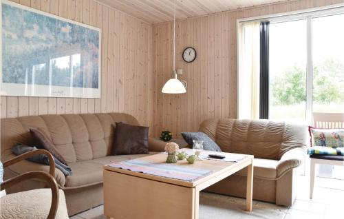 a living room with a couch and a table at Beautiful Home In Vemb With Wifi in Thorsminde