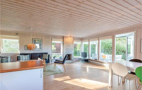 a living room with a table and some chairs at Three-Bedroom Holiday Home In Asperup in Asperup