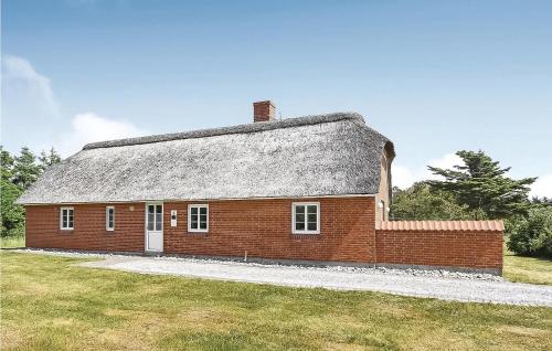 a red brick house with a gray roof at Three-Bedroom Holiday Home In Ulfborg in Sundhuse