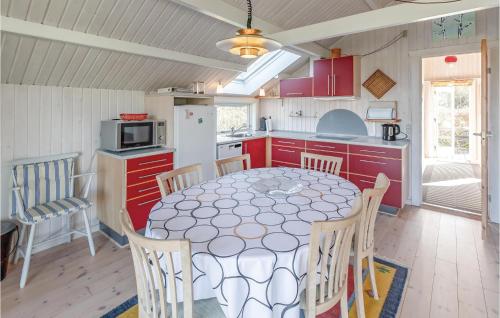 a kitchen with a table and chairs in a room at Three-Bedroom Holiday Home In Brenderup Fyn in Vedelshave