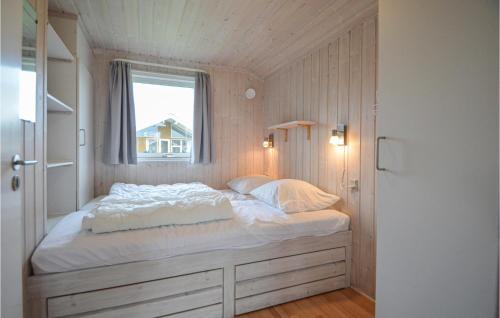 een bed in een kleine kamer met een raam bij Skrbk Fritidscenter in Skærbæk