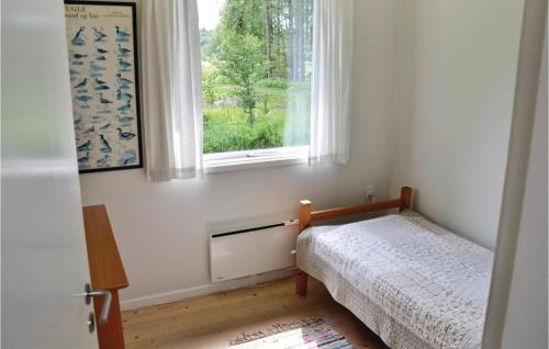 a small bedroom with a bed and a window at Amazing Home In Hirtshals With Wifi in Hirtshals