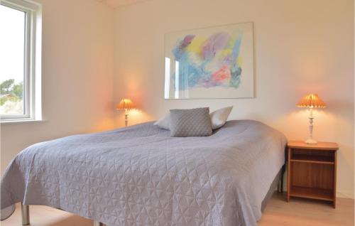 リンケビングにあるBeautiful Home In Ringkbing With 3 Bedrooms And Wifiのベッドルーム1室(ベッド1台、テーブルにランプ2つ付)