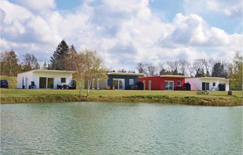 a group of houses next to a body of water at Holiday Home Dyrefolden Ringkøbing Ii in Ringkøbing