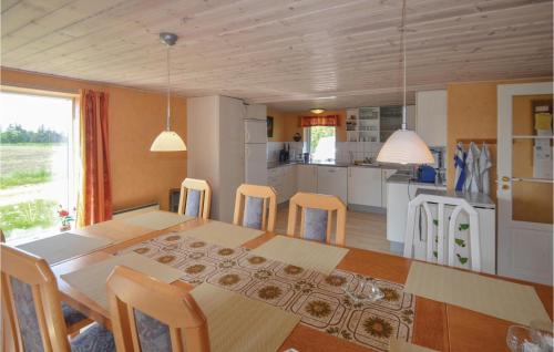 a kitchen and dining room with a table and chairs at Holiday Home Veslos With Fireplace I in Højstrup