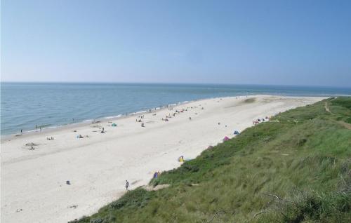 a group of people on a beach near the ocean at Holiday Home Østkrogen Blåvand X in Blåvand