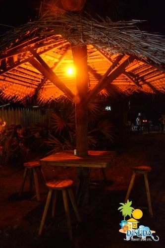 a table with a light on top of a umbrella at Dinuda Resort in Kalpitiya