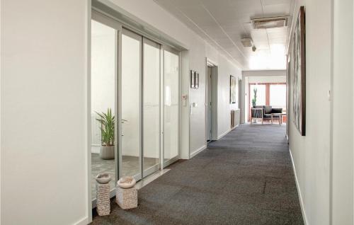 a corridor of an office with glass doors at Lukaf in Thyborøn
