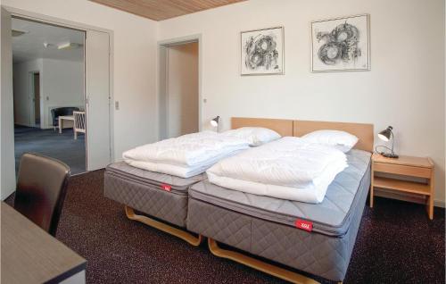 a bed with two pillows on it in a room at Lukaf in Thyborøn