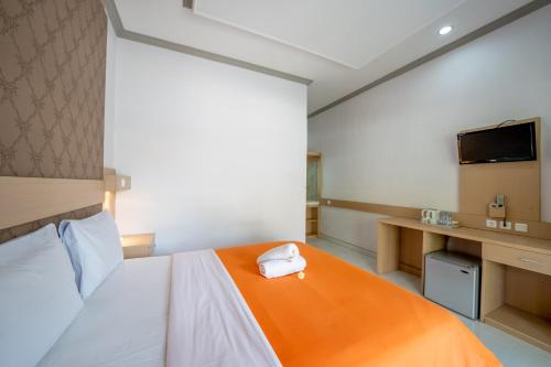 a bedroom with a bed with a towel on it at Bendesa Accommodation in Kuta