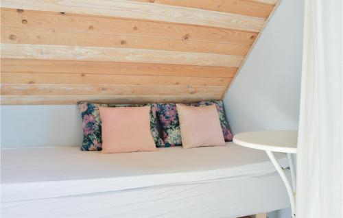 a bench in a room with a wooden ceiling at Two-Bedroom Holiday Home In Lemvig in Nørby