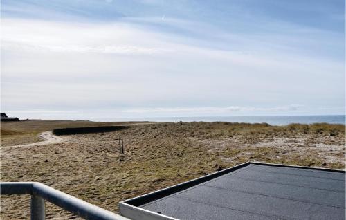 a tennis court on a beach with the ocean in the background at Two-Bedroom Holiday Home In Lemvig in Nørby