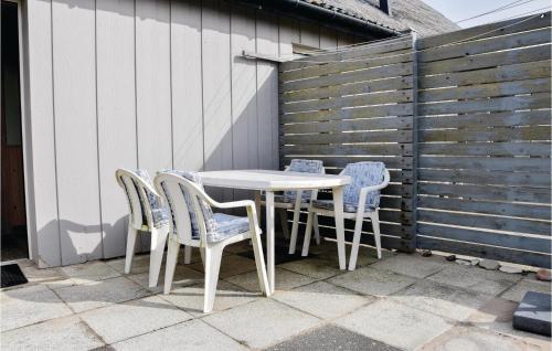 a white table and chairs on a patio at Two-Bedroom Holiday Home In Lemvig in Nørby