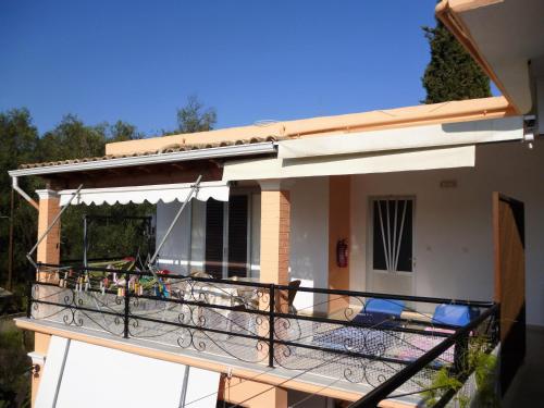 a balcony of a house with chairs on it at Kostas Apartments & studios in Agios Georgios Pagon