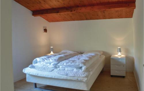 a bedroom with a bed with two lamps on it at Beautiful Home In Grsted With Kitchen in Udsholt Sand