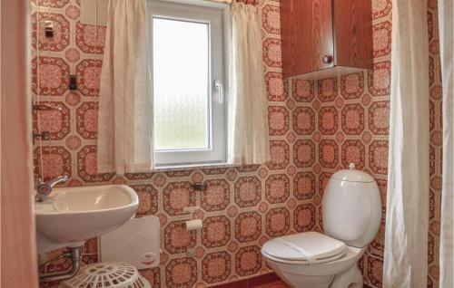 スナーヴィグにあるToms Hytteのバスルーム(トイレ、洗面台付)、窓が備わります。