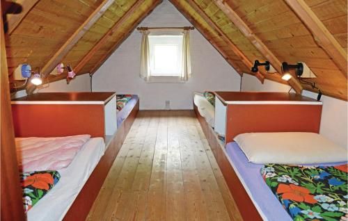 a room with three beds in a attic at Humlebo in Thorsminde