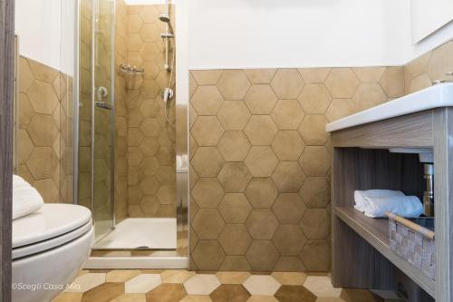 a bathroom with a toilet and a shower at Ottocento Guest House in Alghero