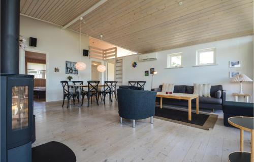 a living room with a couch and a table and chairs at Holiday Home Hoelgårdvej in Kelstrup