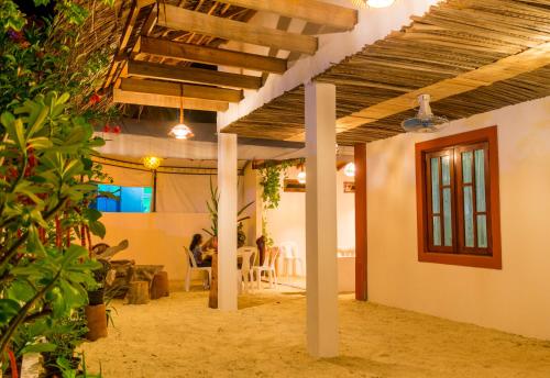 a living room with a wooden ceiling and a table at Masfalhi View Inn in Felidhoo