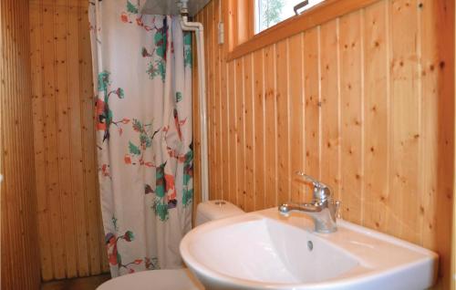 a bathroom with a sink and a toilet and a shower at Amazing Home In Kirke Hyllinge With 3 Bedrooms in Kirke-Hyllinge